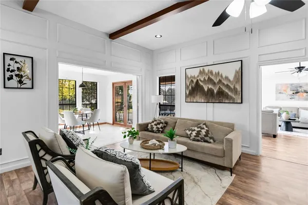 a living room with furniture and wooden floor