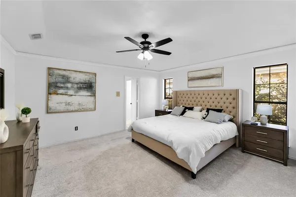 a bedroom with a bed and a large window