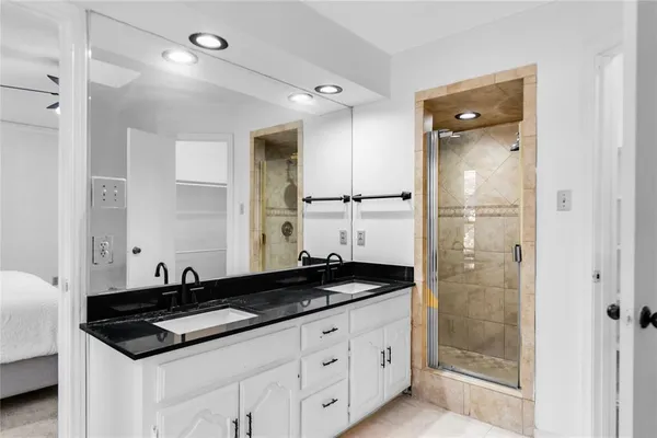 a kitchen with granite countertop a refrigerator and a sink