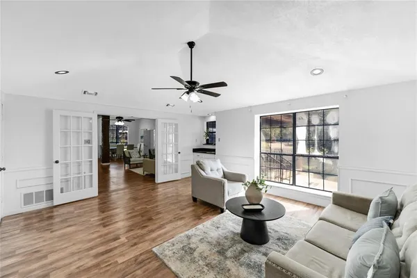 a living room with furniture and a wooden floor