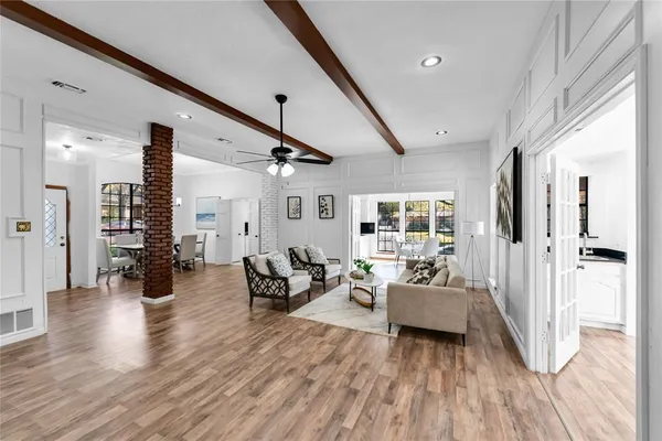 a living room with furniture and wooden floor