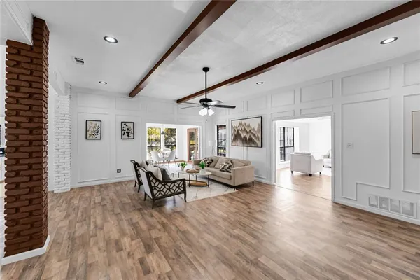 a living room with furniture and wooden floor