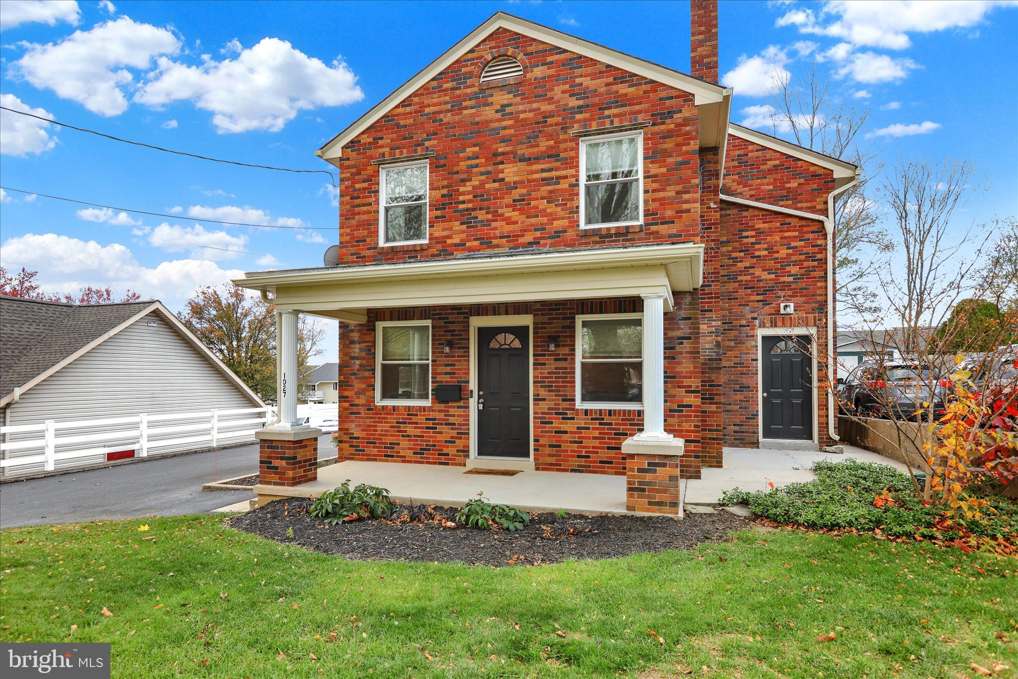 1027 Quentin Road Lebanon, PA 17042 - Photo 1 of 35 a front view of a house with a yard table and chairs