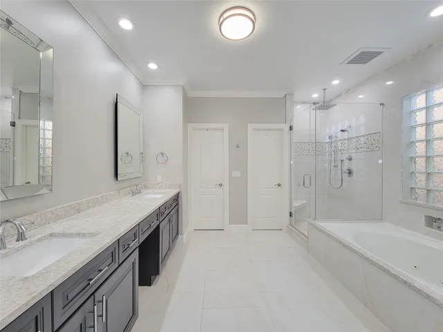 a spacious bathroom with a granite countertop tub sink shower and a mirror