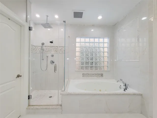 a bathroom with a bathtub and a shower