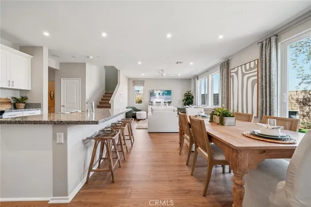 a kitchen with stainless steel appliances kitchen island granite countertop a table and chairs