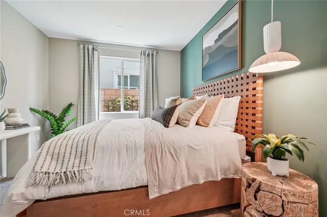 a bedroom with a bed and a mirror