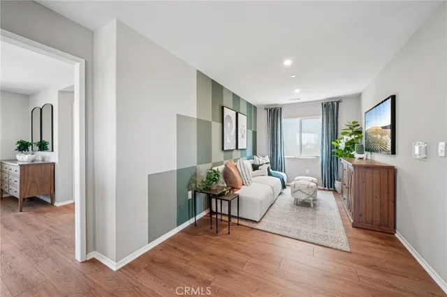 a living room with furniture and a wooden floor