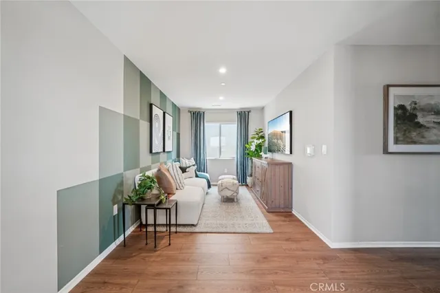 a living room with furniture and wooden floor