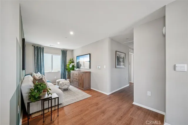 a living room with furniture and flowers