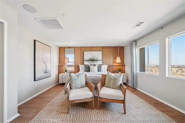 a bedroom with a large bed and windows