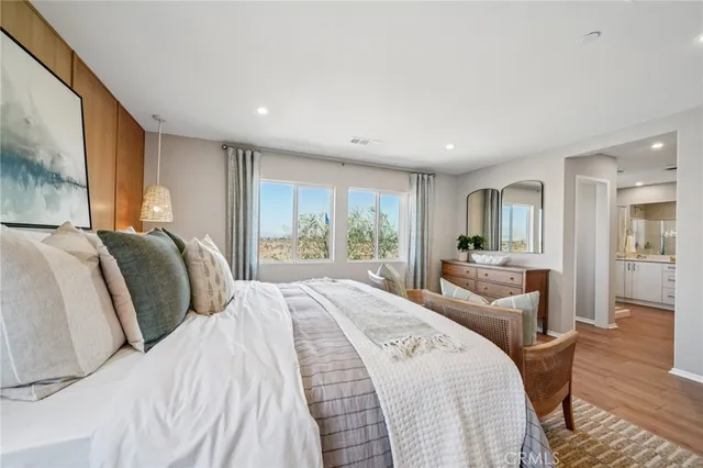 a bedroom with a bed and a large mirror