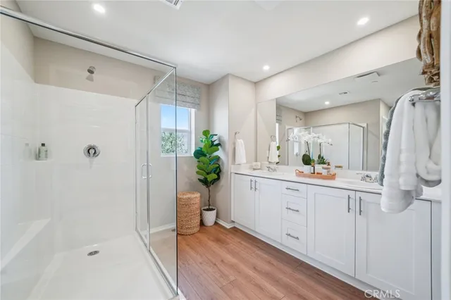 a bathroom with a glass shower door and a mirror