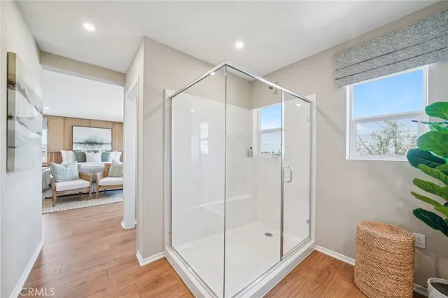 a hallway with cabinets and wooden floor