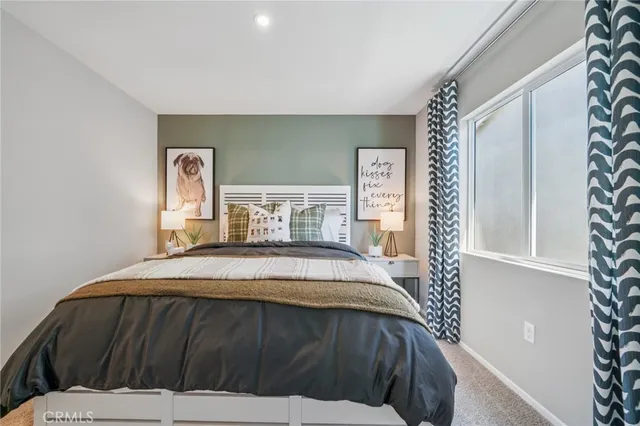 a bedroom with a bed and a painting on the wall