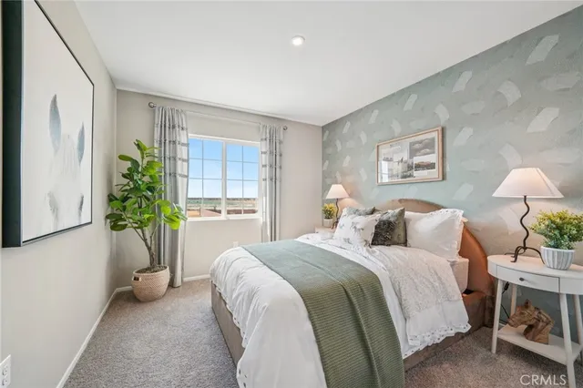 a bedroom with a bed and a potted plant