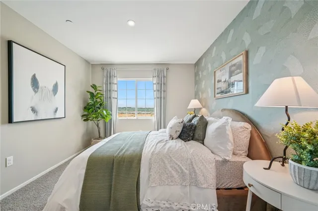 a bedroom with a large bed and a window