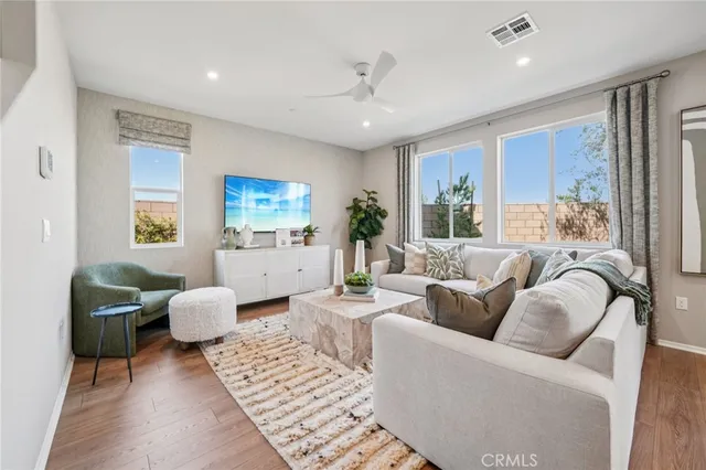 a living room with furniture and wooden floor