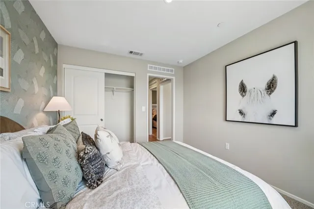 a bedroom with a bed and a dresser