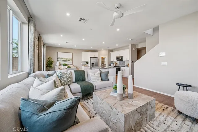 a living room with furniture and kitchen view