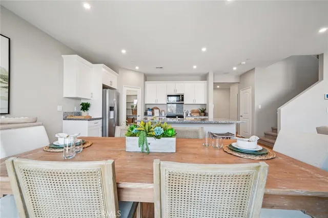 a kitchen with a table and chairs