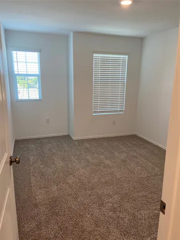 a view of a hallway with wooden shelves