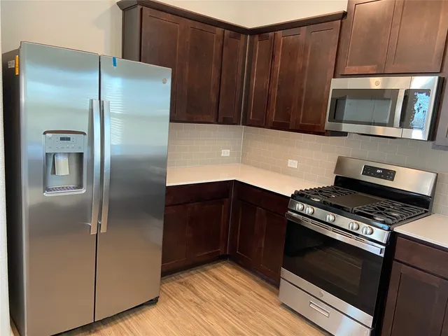 a kitchen with a wooden floor and a sink
