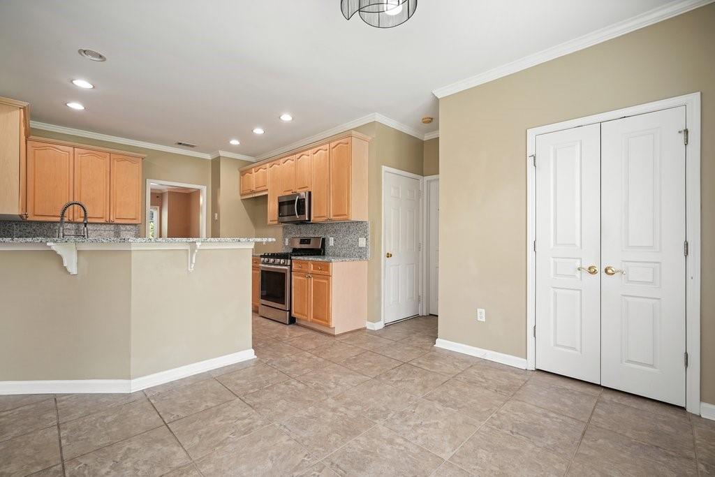 412 Middlebrooke Street Canton, GA 30115 - Photo 12 of 32 a kitchen with stainless steel appliances granite countertop a refrigerator and a stove top oven