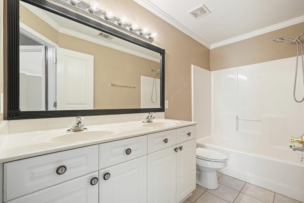 412 Middlebrooke Street Canton, GA 30115 - Photo 21 of 32 a bathroom with a sink a toilet and shower