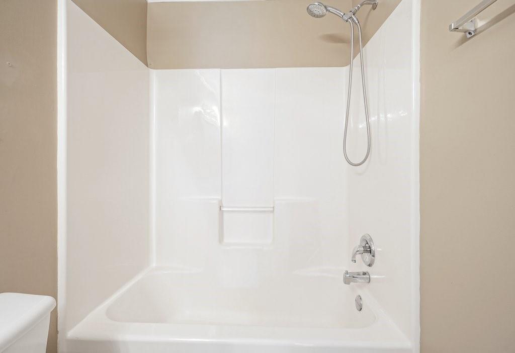 412 Middlebrooke Street Canton, GA 30115 - Photo 22 of 32 a bathroom with a white bath tub and a shower