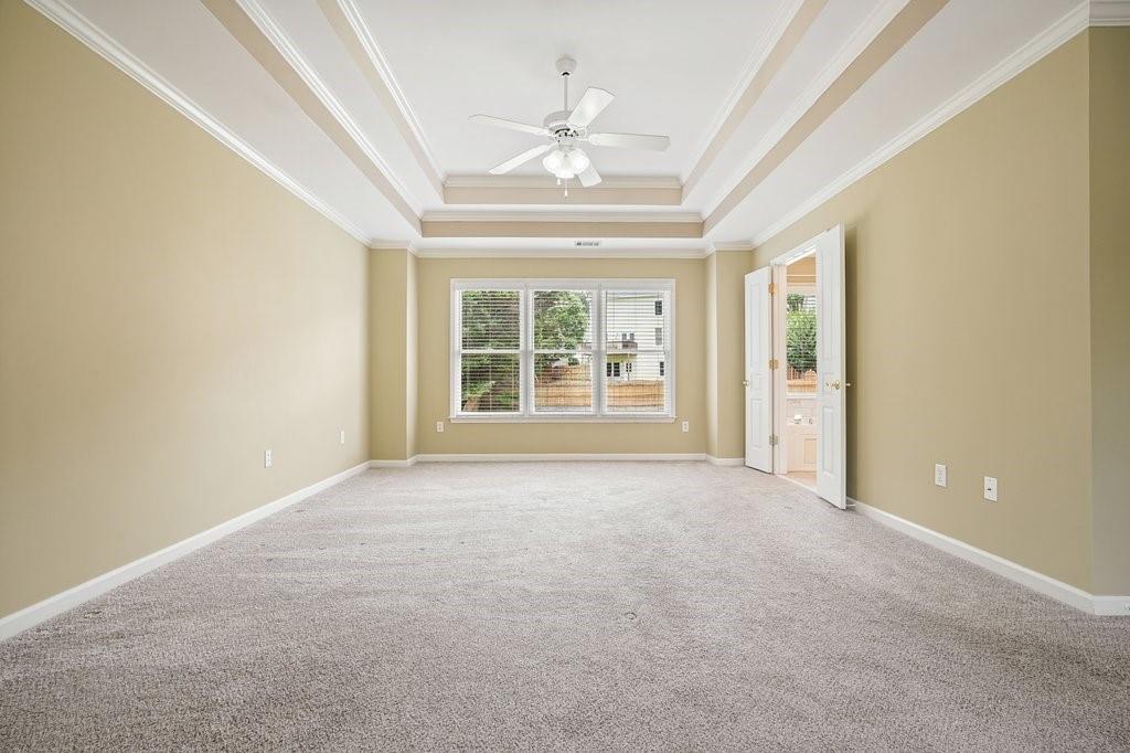 412 Middlebrooke Street Canton, GA 30115 - Photo 26 of 32 an empty room with windows and ceiling fan