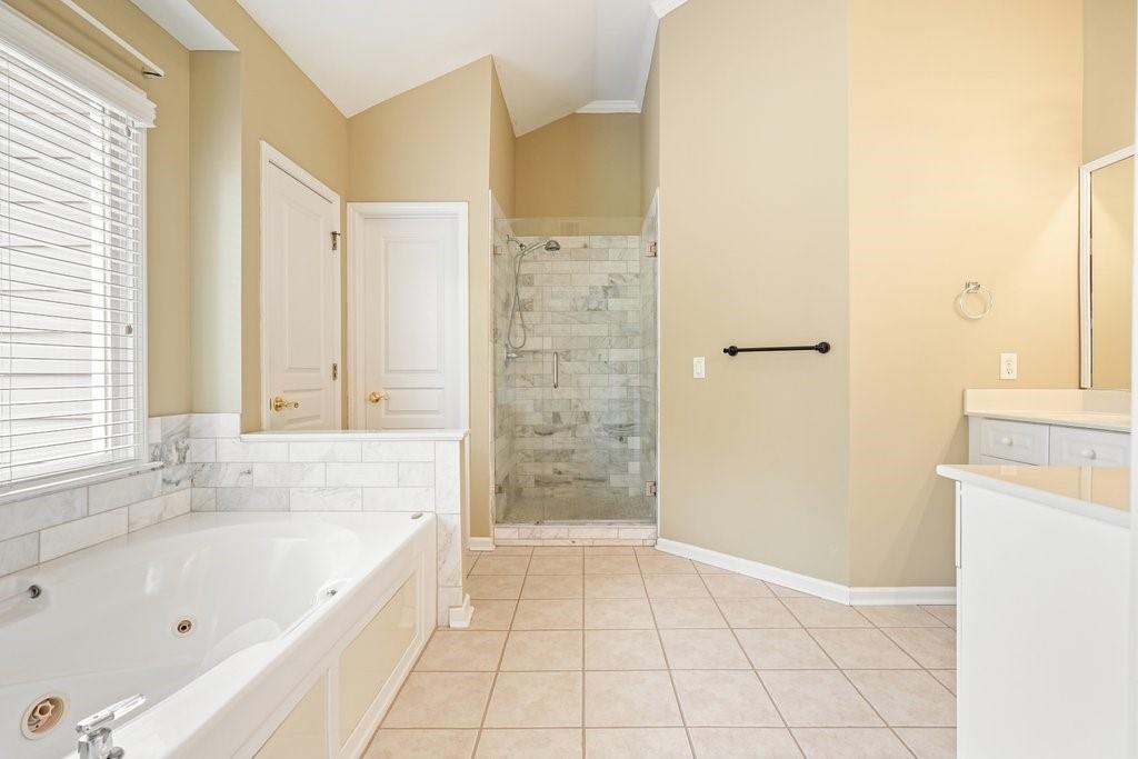 412 Middlebrooke Street Canton, GA 30115 - Photo 28 of 32 a bathroom with a bathtub and a shower