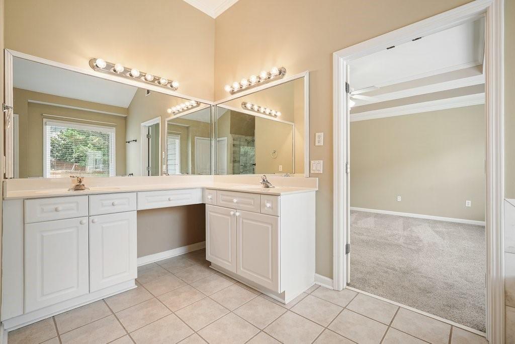 412 Middlebrooke Street Canton, GA 30115 - Photo 29 of 32 a bathroom with a granite countertop sink mirror and cabinets
