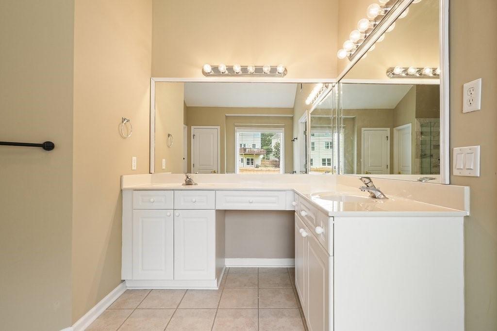 412 Middlebrooke Street Canton, GA 30115 - Photo 30 of 32 a bathroom with a sink and a mirror