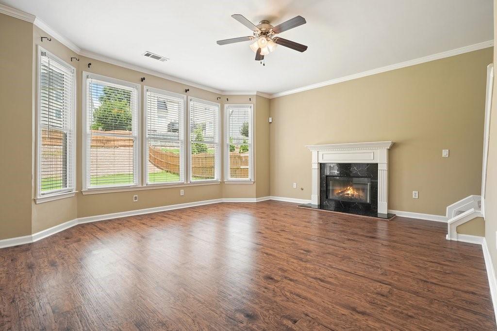412 Middlebrooke Street Canton, GA 30115 - Photo 8 of 32 a view of empty room with wooden floor and fireplace
