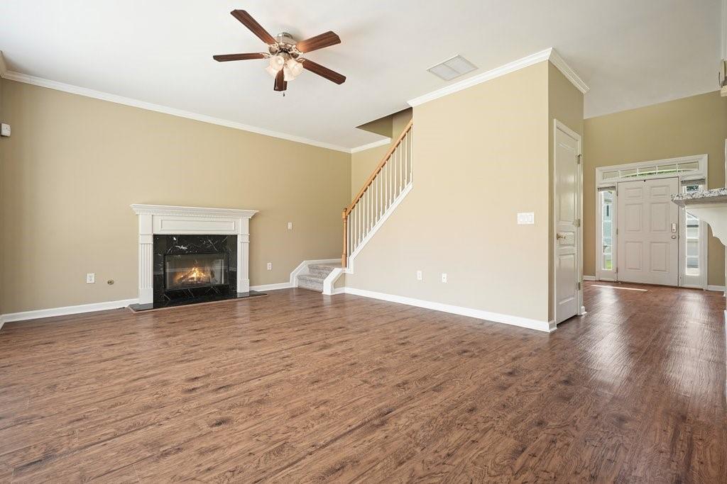 412 Middlebrooke Street Canton, GA 30115 - Photo 9 of 32 a view of a livingroom with wooden floor and a ceiling fan