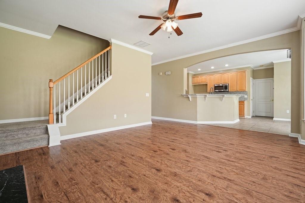 412 Middlebrooke Street Canton, GA 30115 - Photo 10 of 32 a view of a livingroom with wooden floor and a ceiling fan