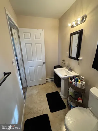 a bathroom with a sink a toilet a mirror and vanity