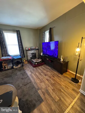 a living room with furniture gym equipment and a flat screen tv