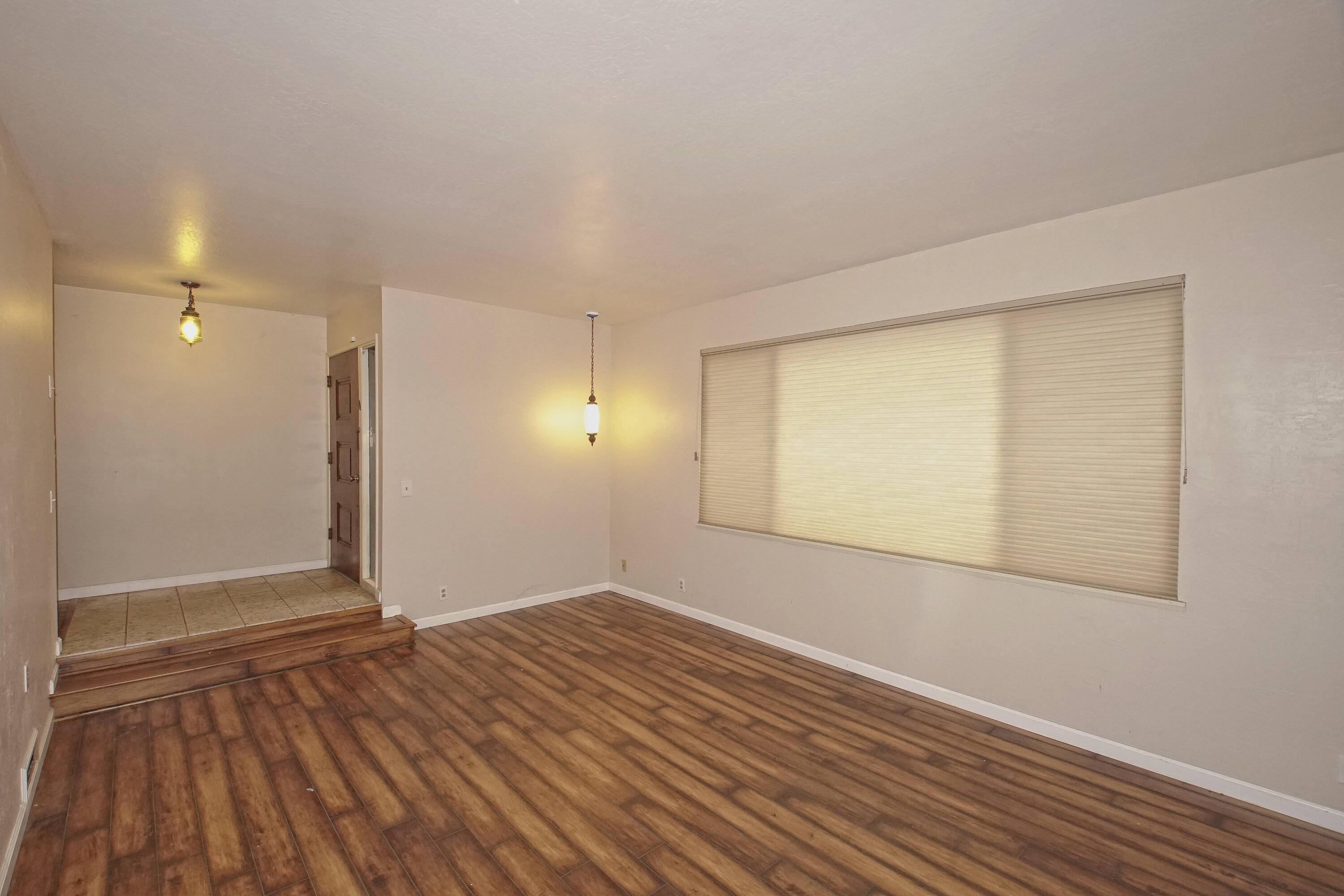 8440 Redbank Road Redding, CA 96001 - Photo 19 of 49 a view of an empty room with wooden floor and a window