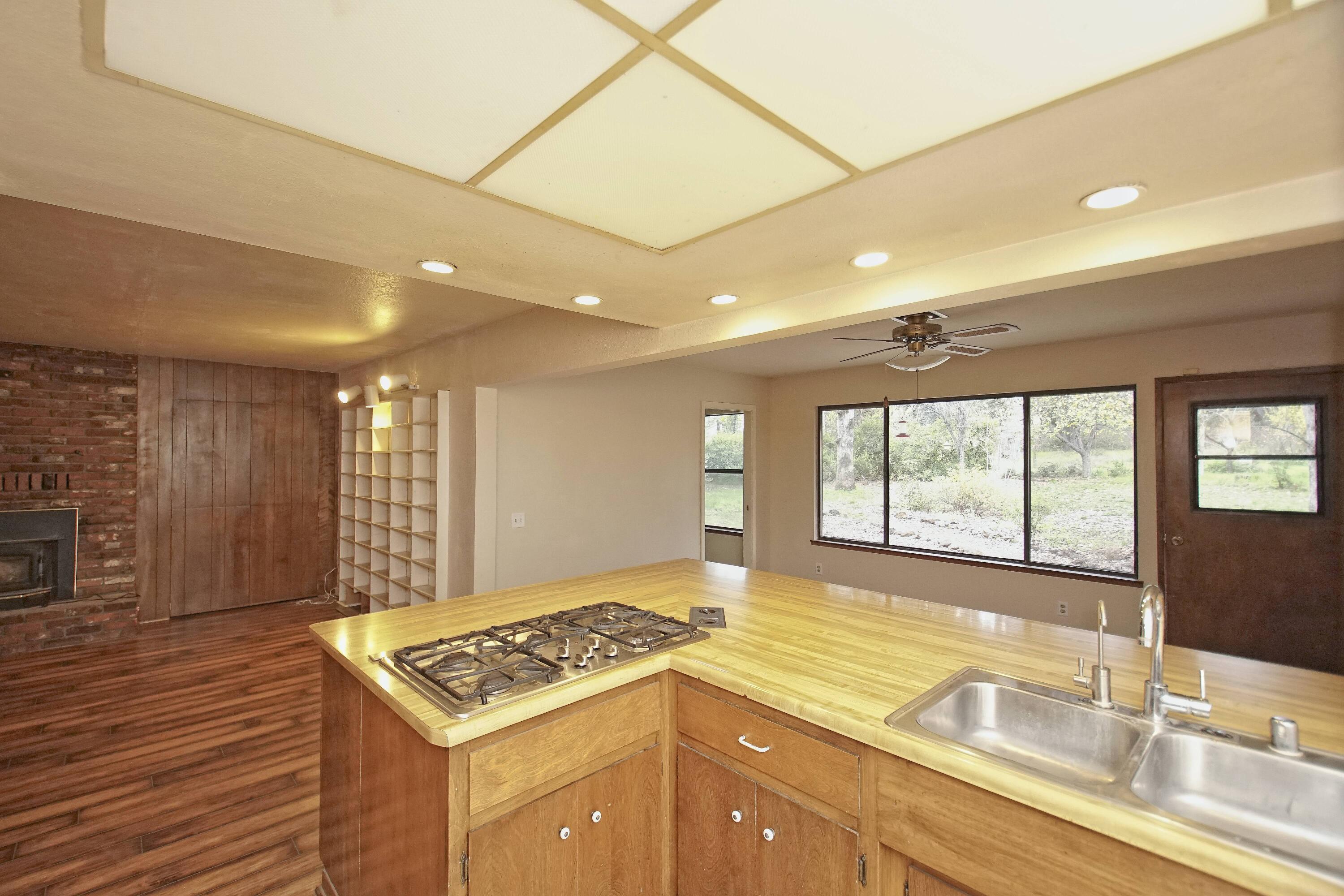 8440 Redbank Road Redding, CA 96001 - Photo 25 of 49 a kitchen with a stove a sink and a refrigerator