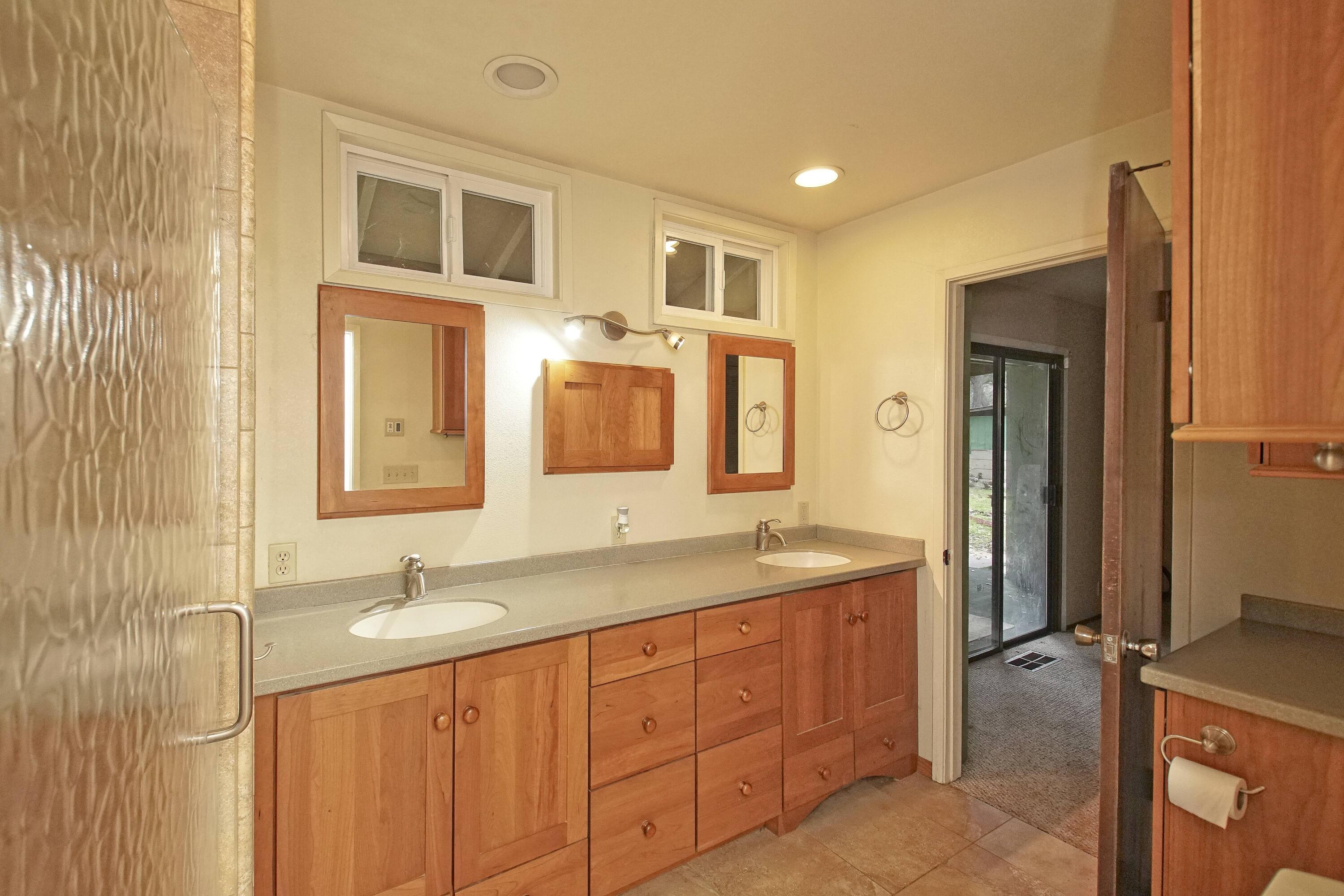 8440 Redbank Road Redding, CA 96001 - Photo 30 of 49 a bathroom with a granite countertop double vanity sink mirror and