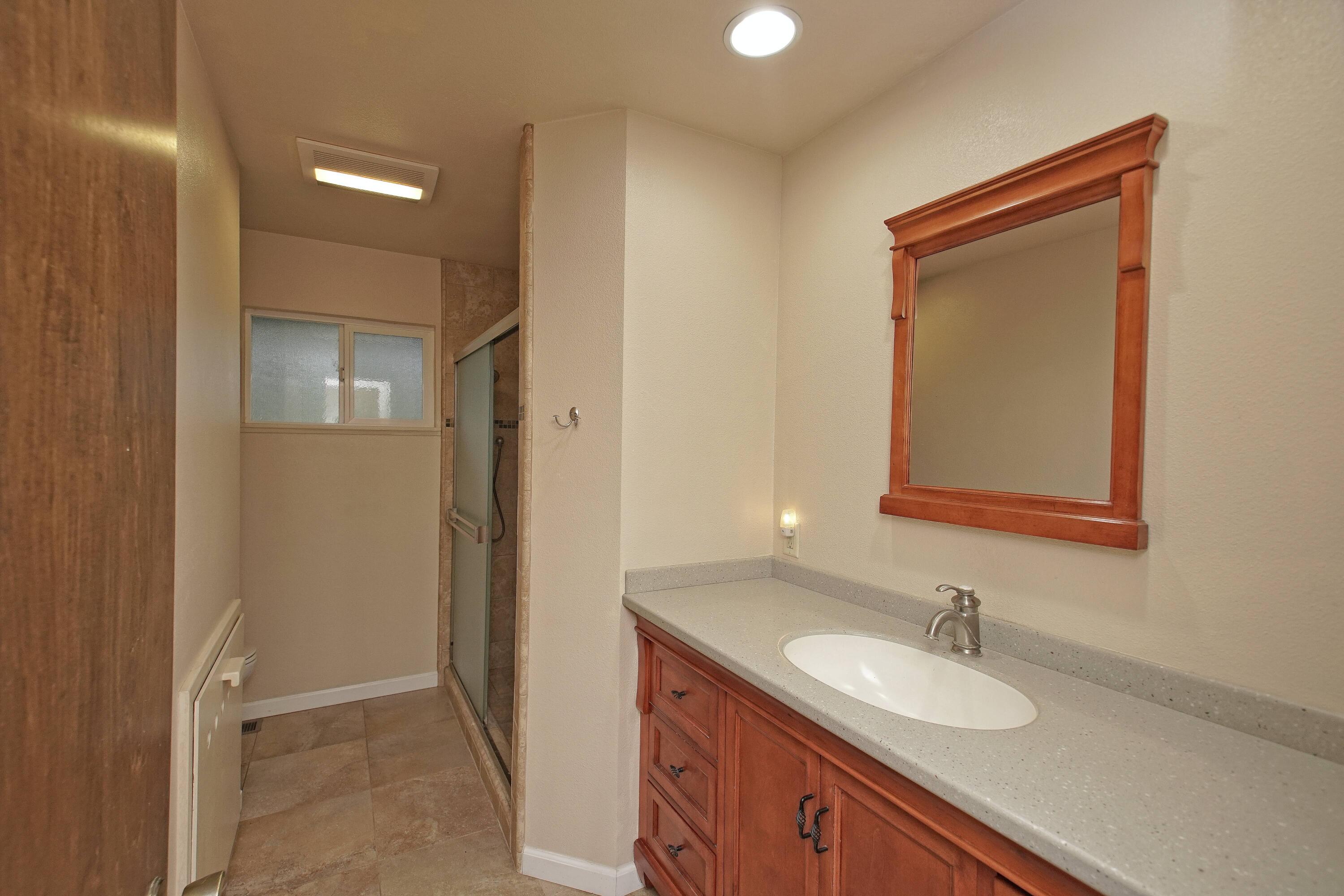 8440 Redbank Road Redding, CA 96001 - Photo 34 of 49 a bathroom with a granite countertop sink and a mirror