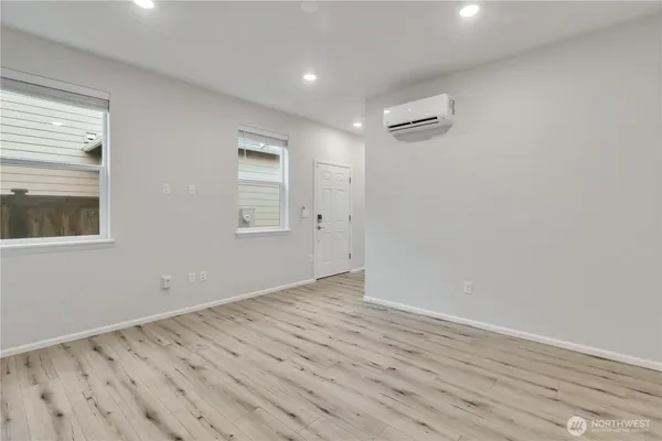 wooden floor in an empty room with a window