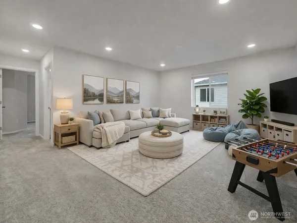 a living room with furniture a flat screen tv and a window