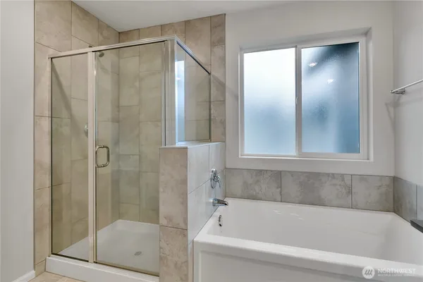 a bathroom with a bathtub and a shower