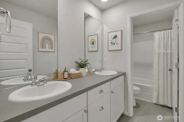 a bathroom with a double vanity sink and a mirror