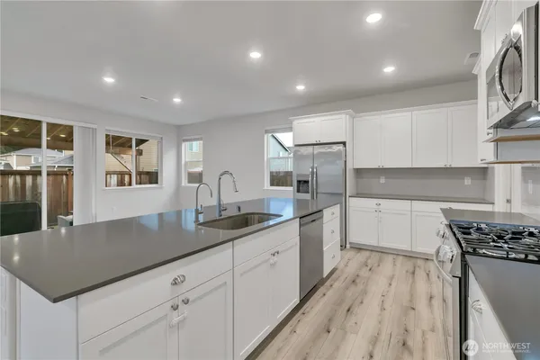 a kitchen with a sink stove and cabinets