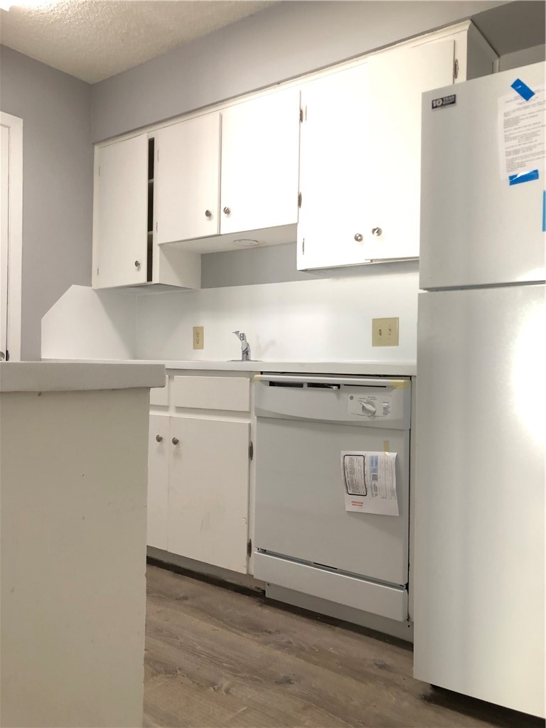6502 South 1st Street, Unit 102 Austin, TX 78745 - Photo 6 of 26 a kitchen with appliances cabinets and a sink