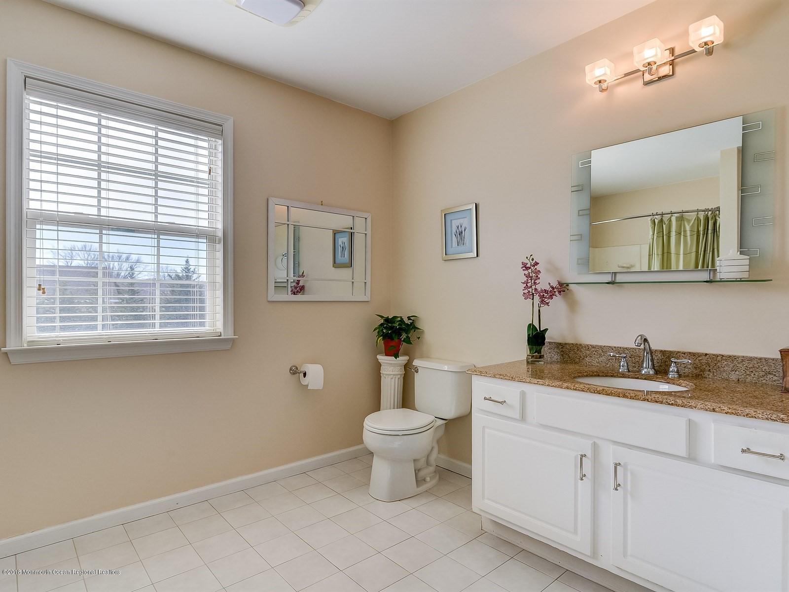 13 Hamilton Road Englishtown, NJ 07726 - Photo 17 of 24 a bathroom with a toilet sink and mirror